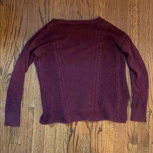 This is a maroon colored sweater